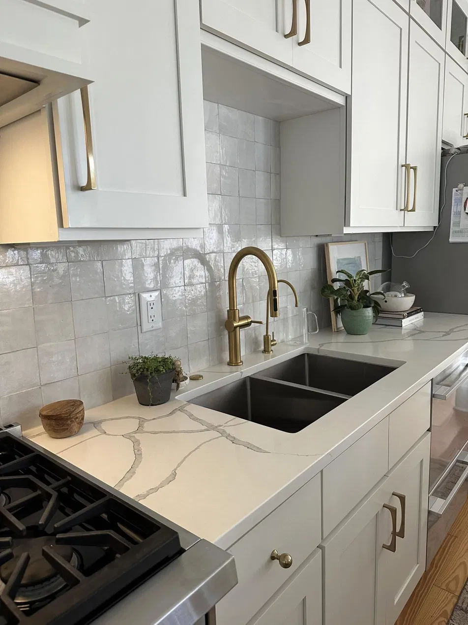 Kitchen backsplash with zellige tile, quartz countertop, and gold faucet by CNB Renovations Charleston SC